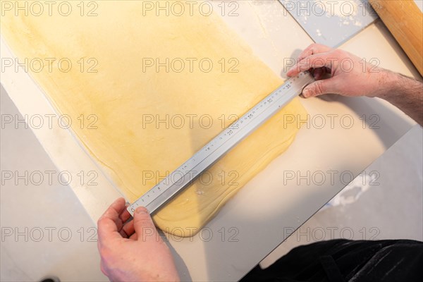 Confectioner man baking homemade croissants