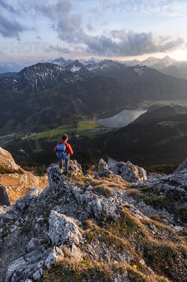 Hiker at the summit of Schartschrofen at sunset