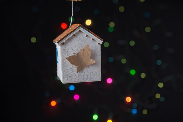 Paper butterfly on a Model house on a bokeh light