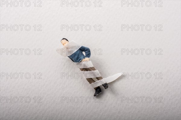 Tiny figurine of man miniature model wrapped in bandages