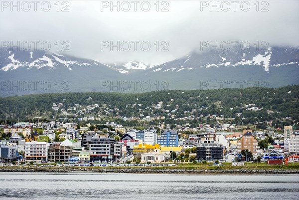 View of Ushuaia city on a cloudy day from the ocean. Tierra del Fuego
