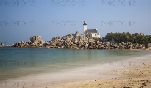 Phare de Pontusval lighthouse on granite rocks on sandy beach Plage du Phare