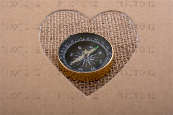 Compass as instrument through a heart shaped hole