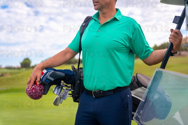 Portrait of a Caucasian man playing golf in a buggy