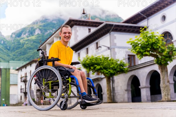 Portrait of a disabled person in a wheelchair walking through the town square