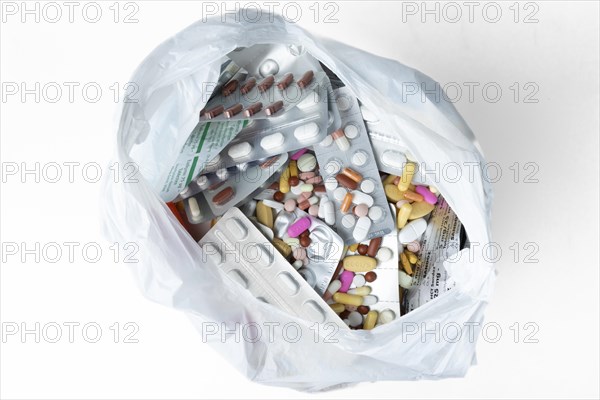 Coloured pills and capsules with and without packaging in rubbish bag
