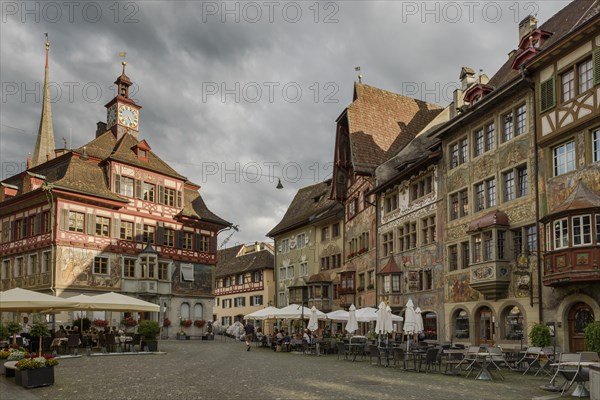 Town hall and medieval half-timbered houses with facade paintings on Rathausplatz in the old town