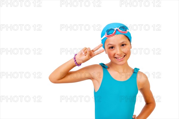 Portrait of girl with swimsuit and diving goggles for swimming lessons in the pool making the victory symbol. White background