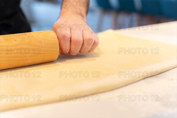 Confectioner man baking homemade croissant