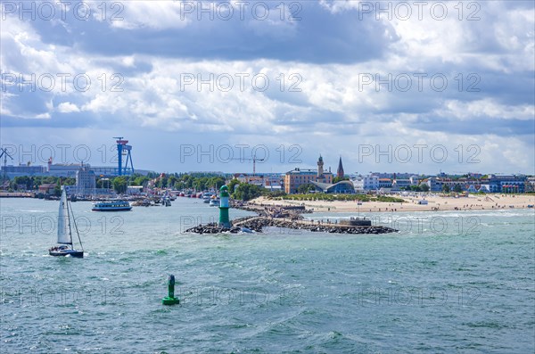 Maritime atmosphere around the West Pier against the picturesque backdrop of Rostock-Warnemuende