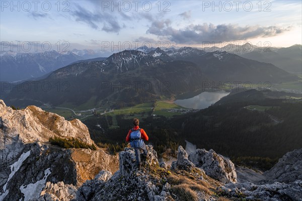 Hiker at the summit of Schartschrofen at sunset