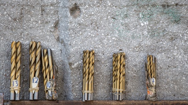 Drill bits grouped into different sizes in view