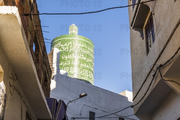 Important green tower with arabic letters in Moulay Idriss downtown