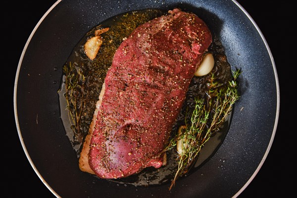 Top view of duck breast in a frying pan