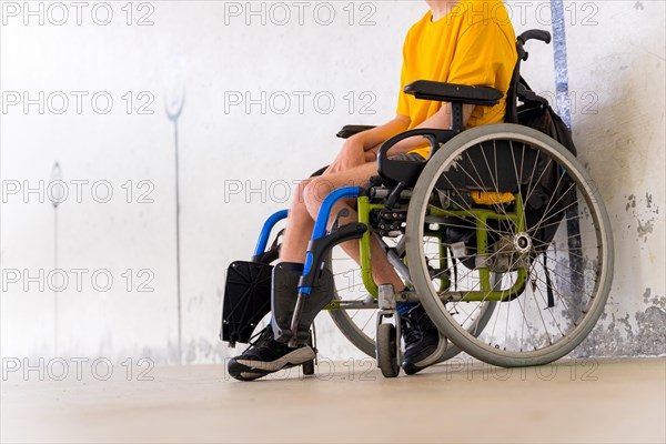 Detail of a disabled person in a wheelchair at a Basque pelota game fronton