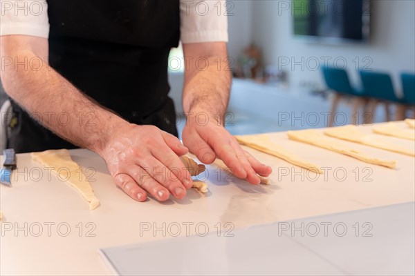 Detail of a man's hands baking croissants