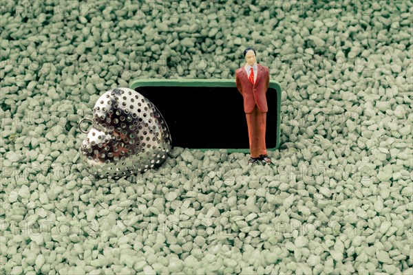 Heart and tiny man figurine model and notice board