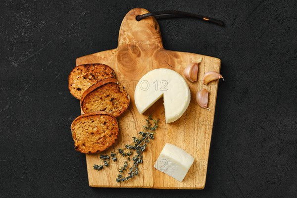 Top view of small goat cheese head and garlic toasted bread