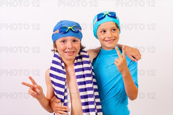 Brothers dressed and hugged in their swimsuits for swimming lessons in the pool in the summer. White background