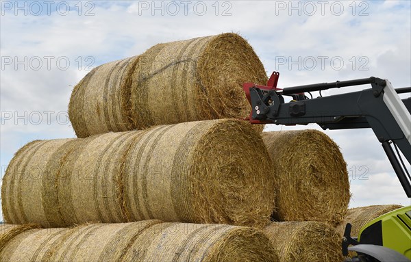 Tractor with bale fork stacking round bales