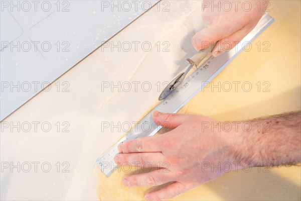 Confectioner man baking homemade croissants