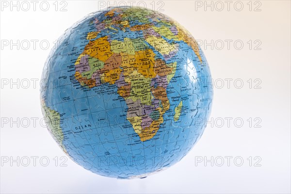 Globe made of puzzle pieces with a view of the continent of Africa