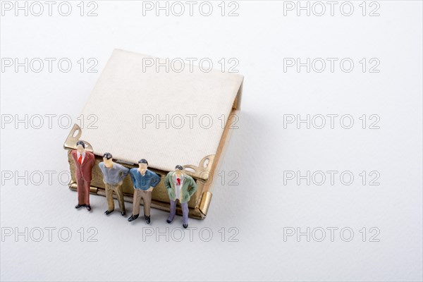 Tiny figurine of men models found beside a book