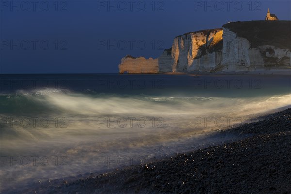 Etretat beach with view of Falaise d'Amont and Chapelle Notre-Dame de la Garde