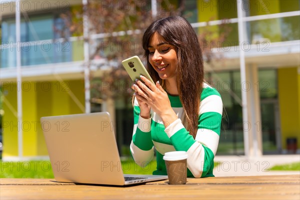 Portrait of a caucasian girl working with a computer in nature