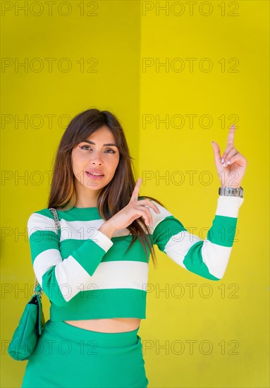 Caucasian girl pointing up with copy space