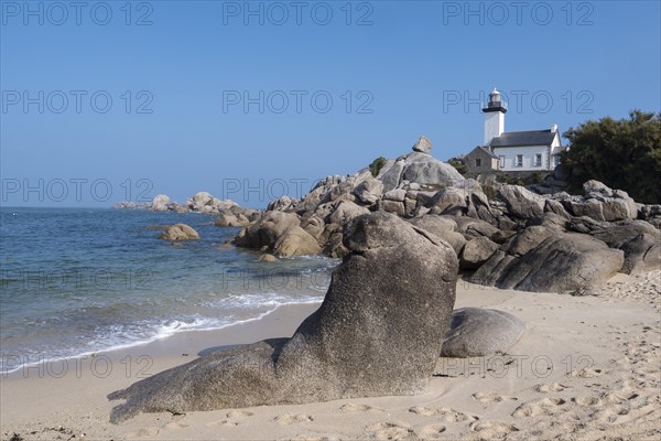 Phare de Pontusval lighthouse on granite rocks on sandy beach Plage du Phare