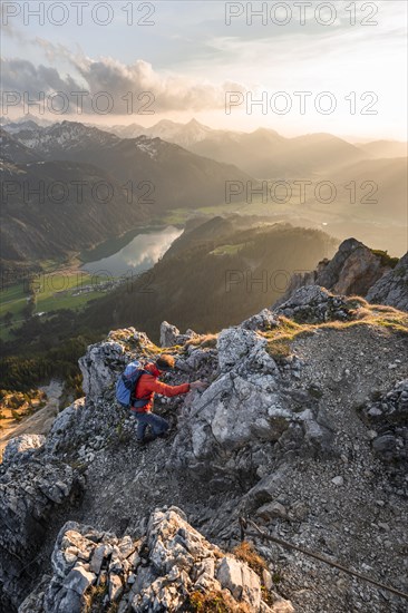 Hiker at the summit of Schartschrofen at sunset