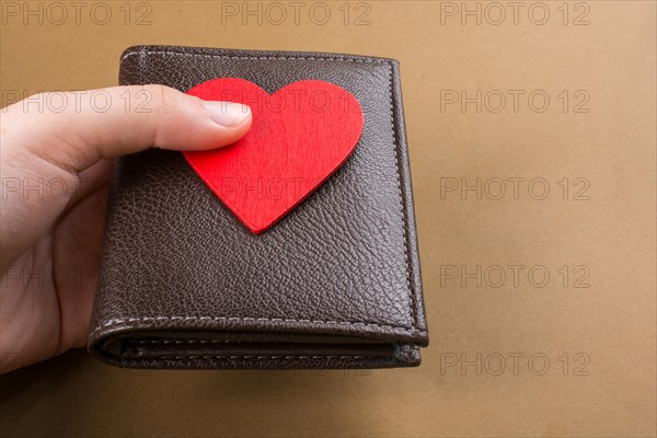 Brown leather wallet in hand saving and finance concept