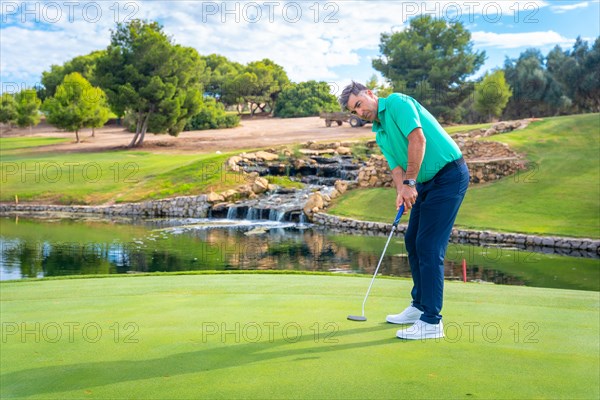 Playing golf at golf club by a lake on the green