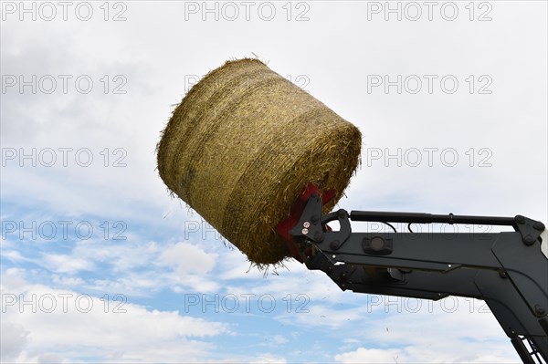 Tractor with bale fork stacking round bales