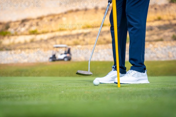 Playing golf at golf club on the green