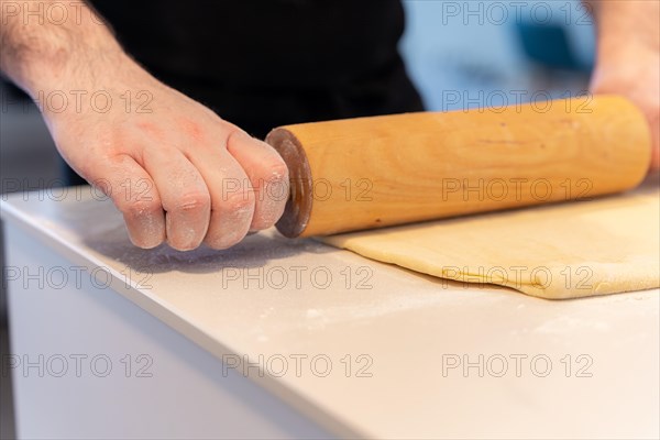 Confectioner man baking homemade croissant