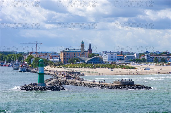 Maritime atmosphere around the West Pier against the picturesque backdrop of Rostock-Warnemuende