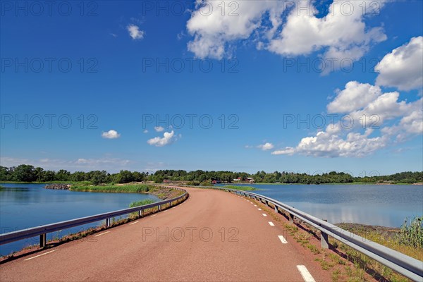 Traffic-free road leads past shallow bays with crystal-clear water