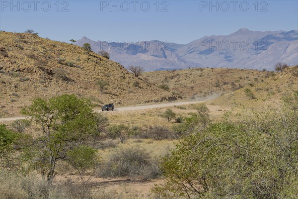 Off-road car driving on a typical gravel road