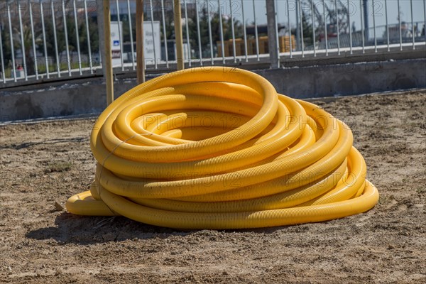 Yellow plastic water hose closeup in the view