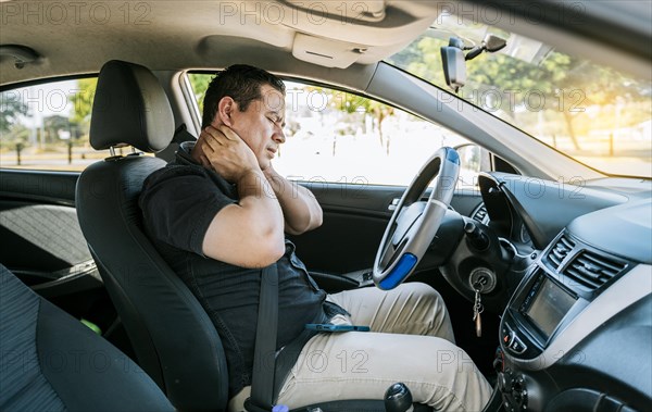 Exhausted driver with neck pain in traffic