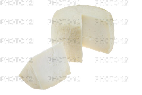 Small head of goat cheese with one section isolated on white background