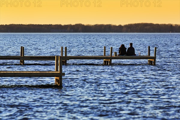 Couple sitting on jetty