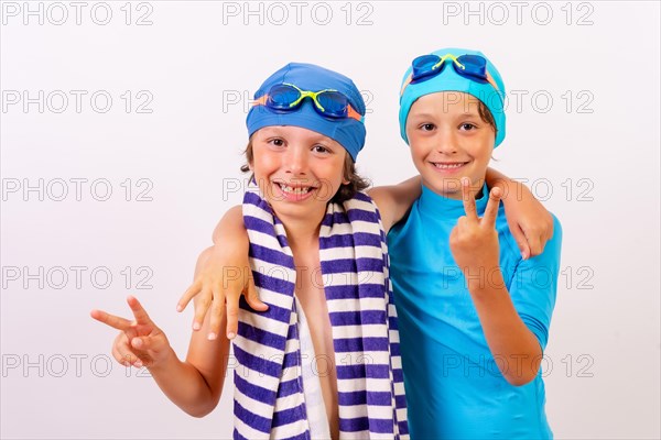 Brothers dressed and hugged in their swimsuits for swimming lessons in the pool in the summer. White background