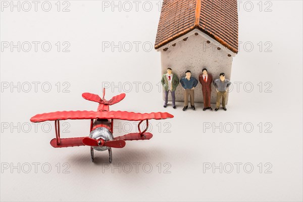 Airplane and tiny figurine of man miniature model in view