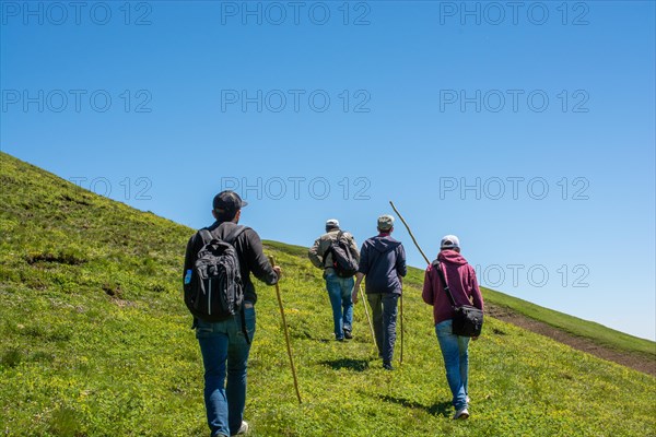 Hikers with backpacks and trekking poles walking in Turkish highland