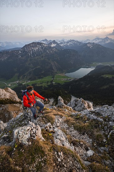 Hiker at the summit of Schartschrofen at sunset