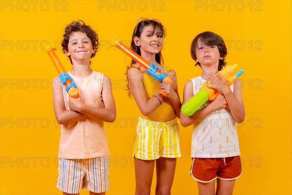 Children with water pistols on summer vacation