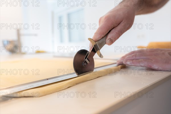 Confectioner man baking homemade croissants